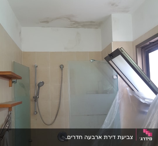 כתמי רטיבות ועובש בתקרת חדר אמבטיה לפני עבודת צביעה